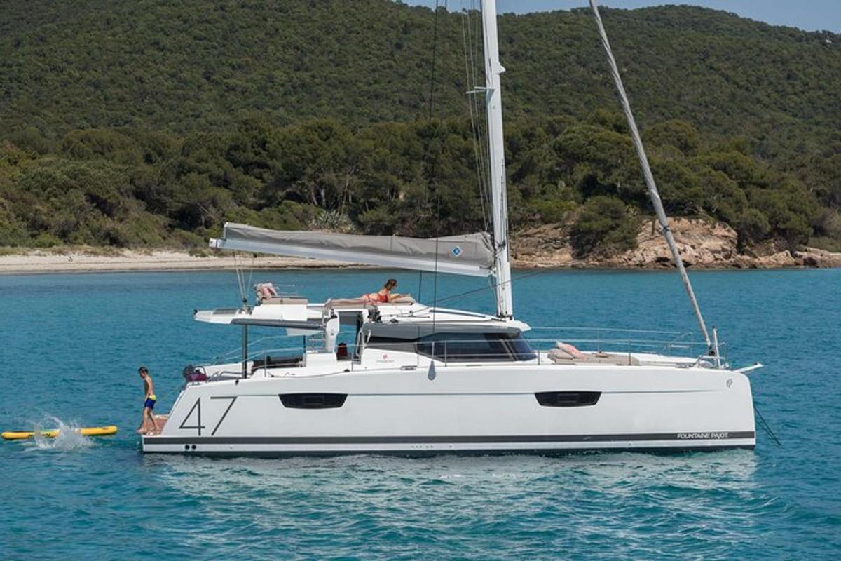 a white boat in the water with people on it