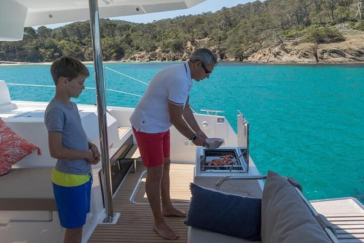 a man and a boy standing on the deck of a boat