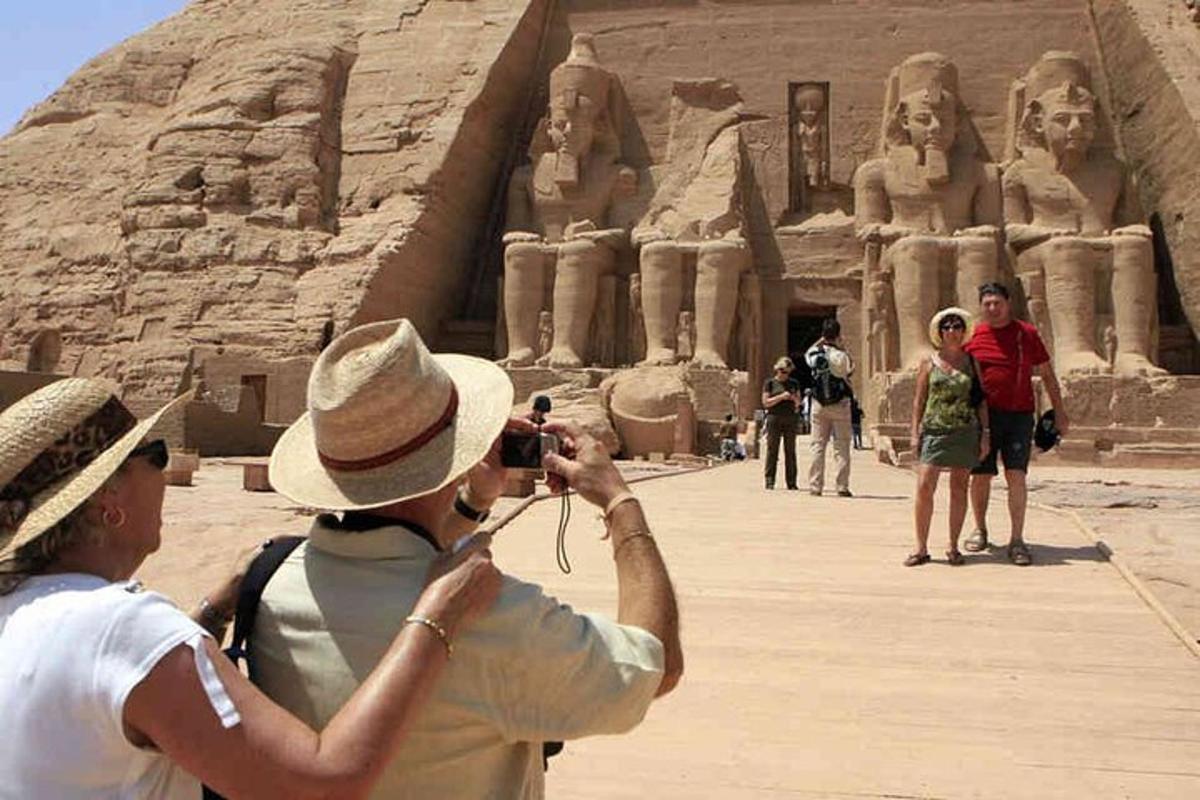 a man taking a picture of a group of people standing in front ofaraoharaoh