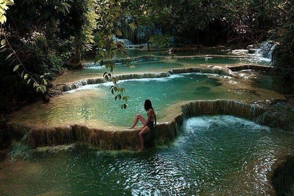 seorang wanita duduk di atas rakit di kolam air