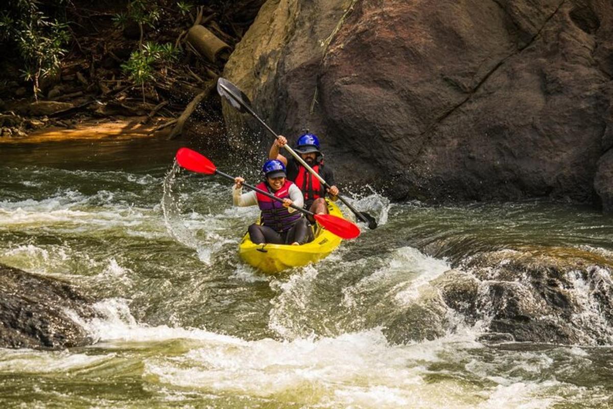 two people in a kayak in a river