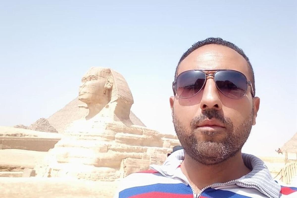 a man in sunglasses standing in front of thearaoharaoh