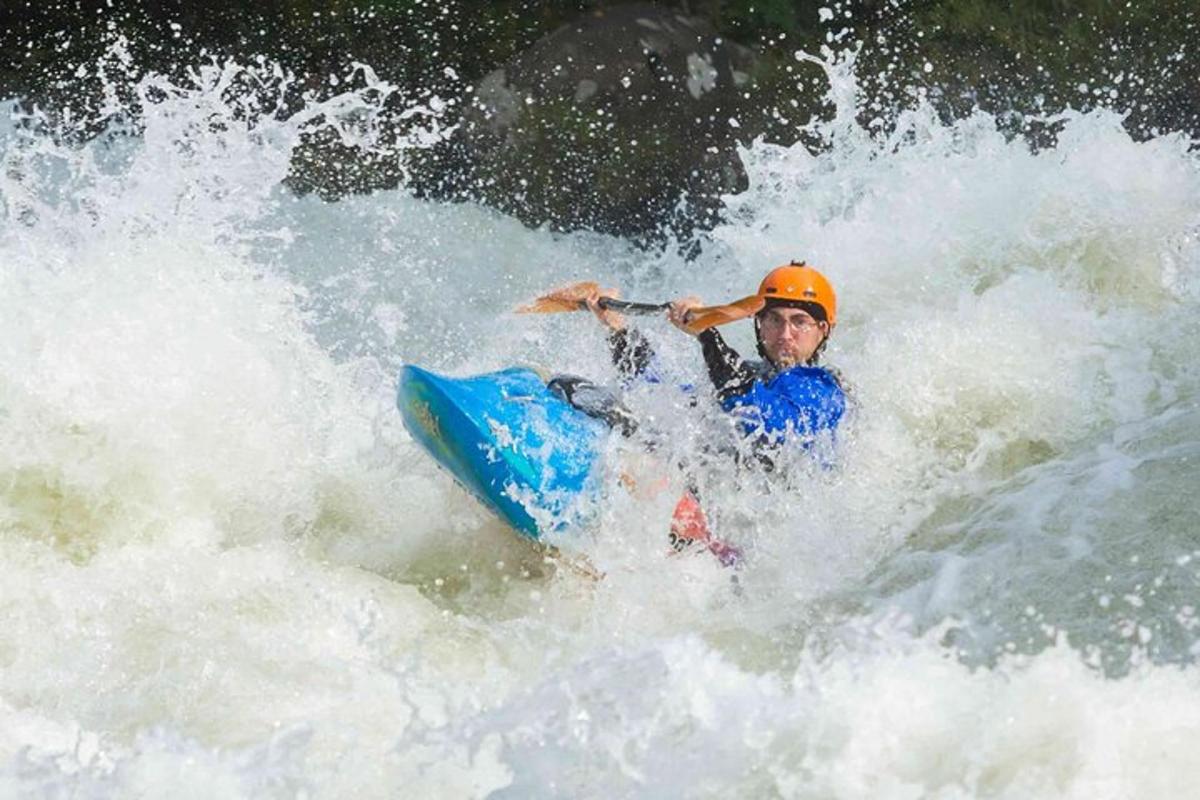 a man riding a wave on a raft in the water
