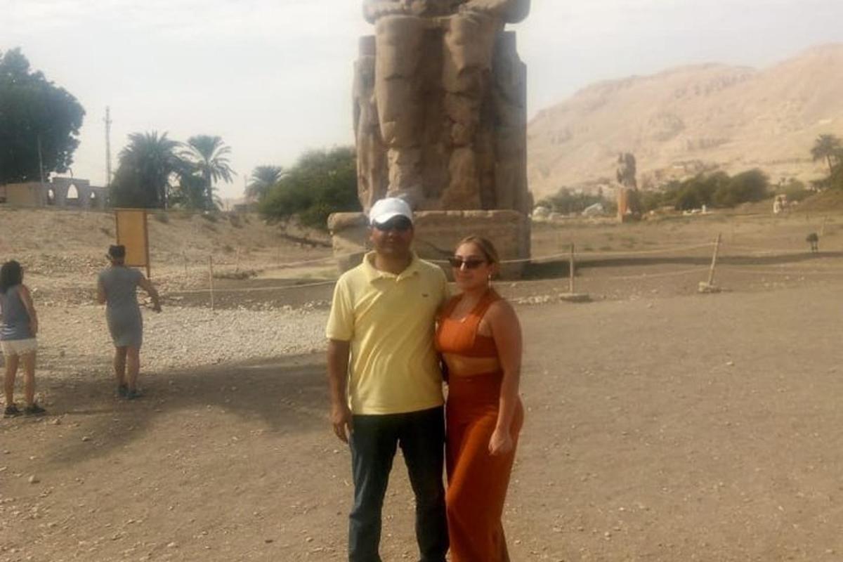a man and a woman standing in front of a monument