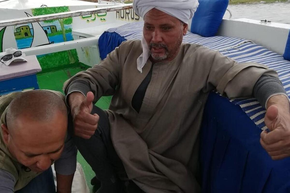 a man giving a thumbs up on a boat