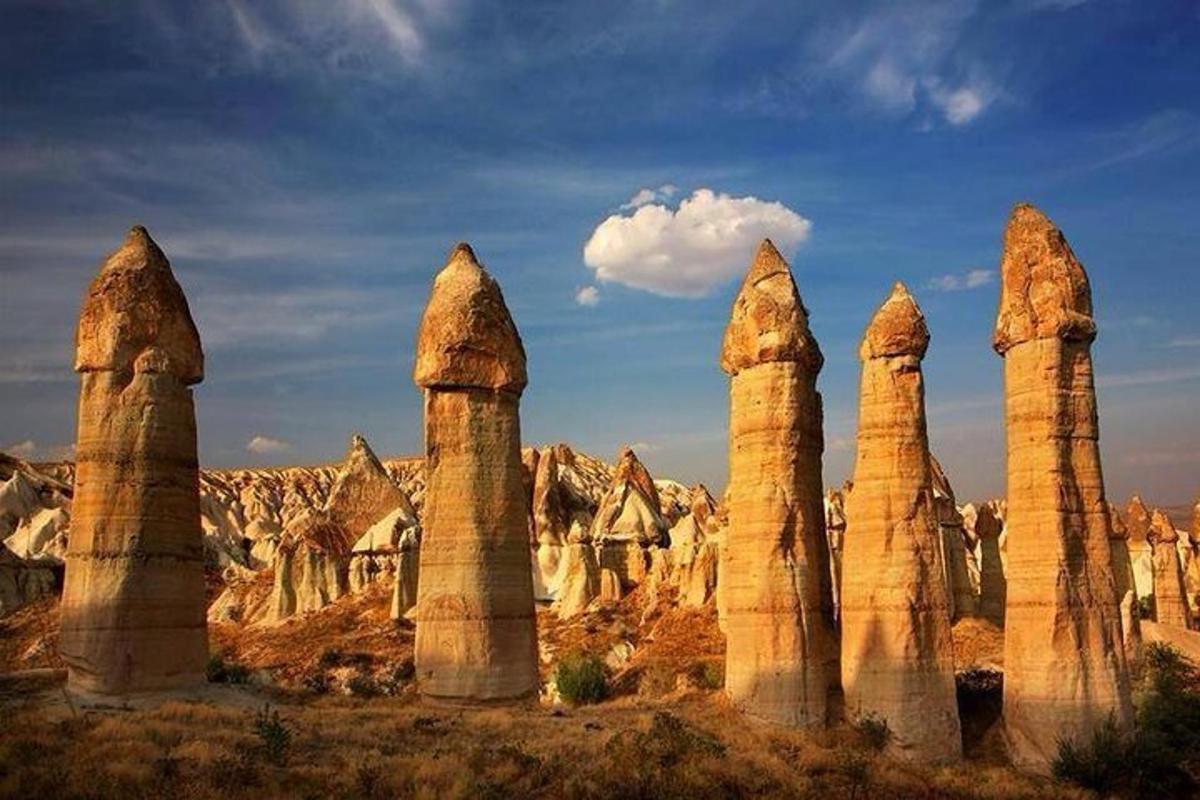a group of tall stone pillars in a desert