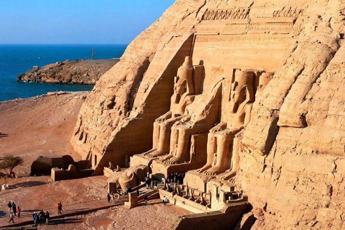 a large sand castle on a cliff next to the ocean