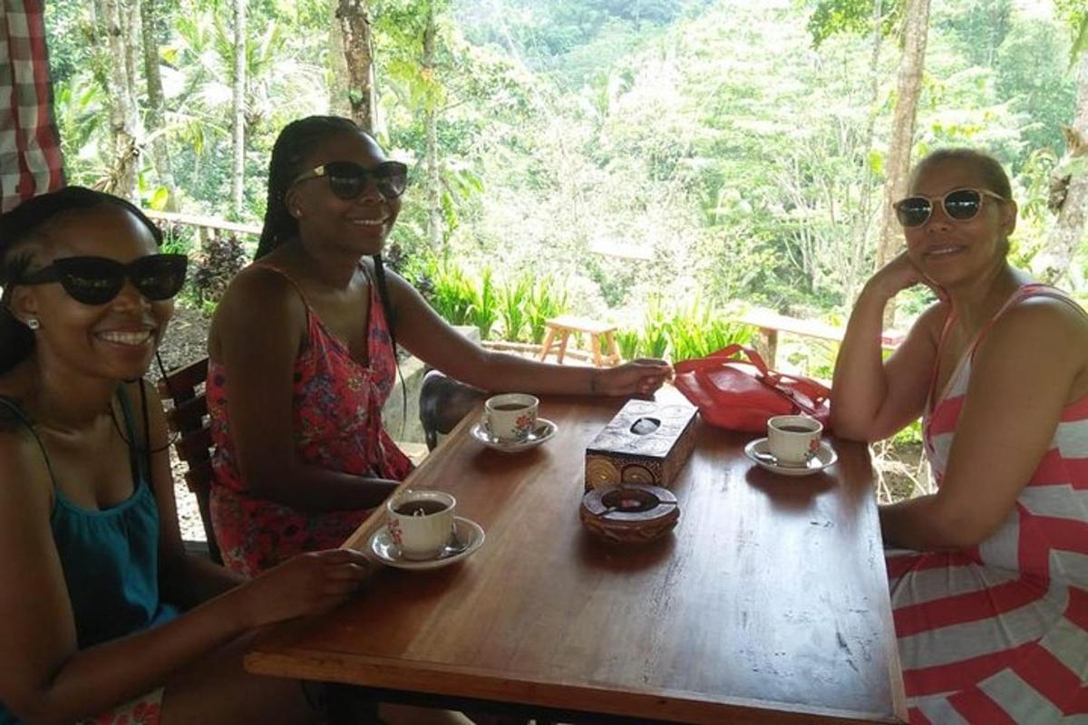 three women sitting at a table with cups of coffee