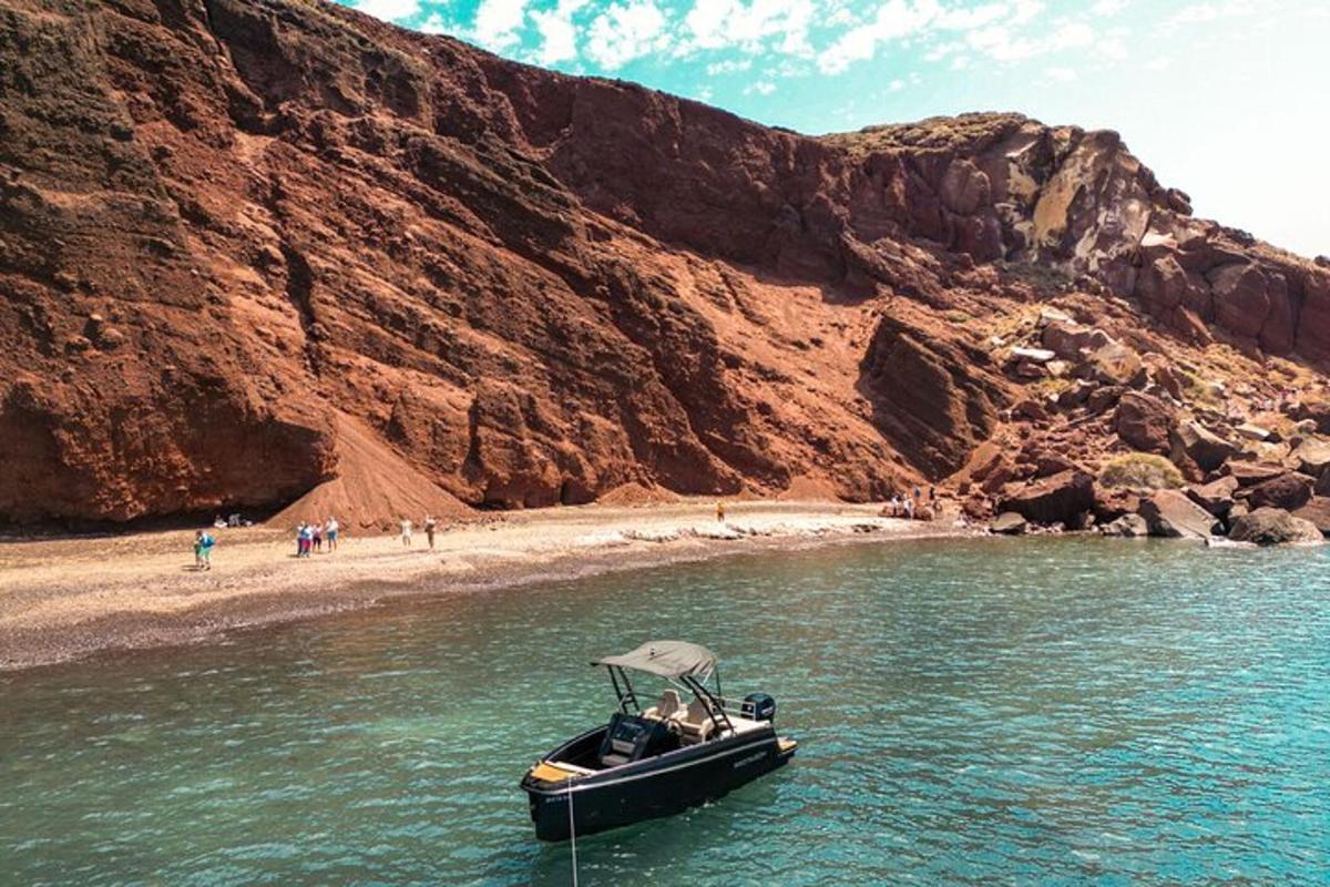 a boat in the water next to a beach