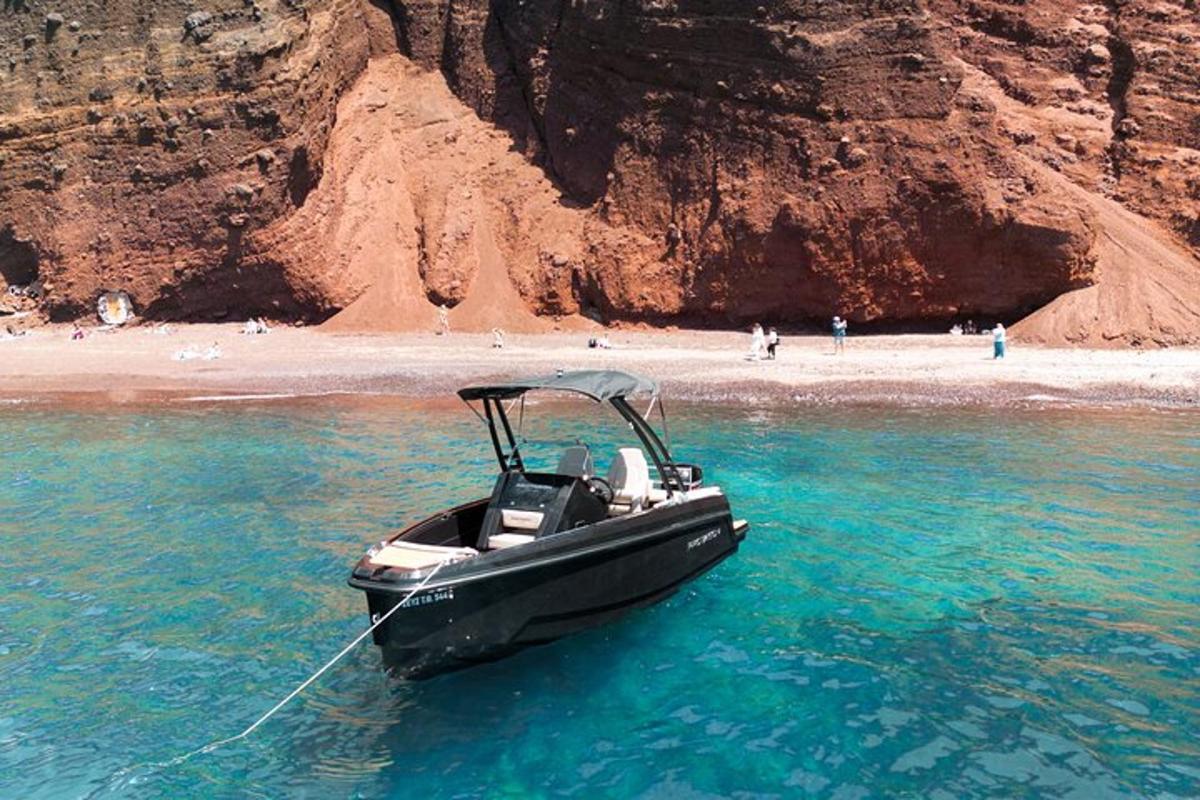 a boat in the water next to a beach