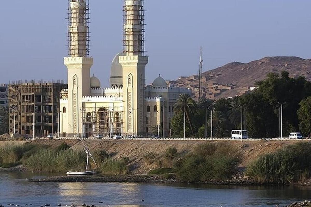 a large building with two towers in front of a river