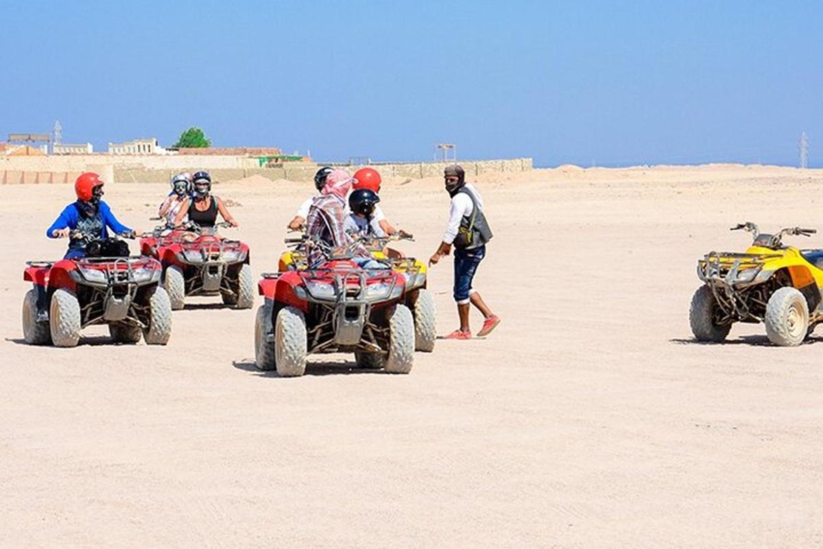 un grup de oameni care se plimbă cu ATV-uri pe plajă