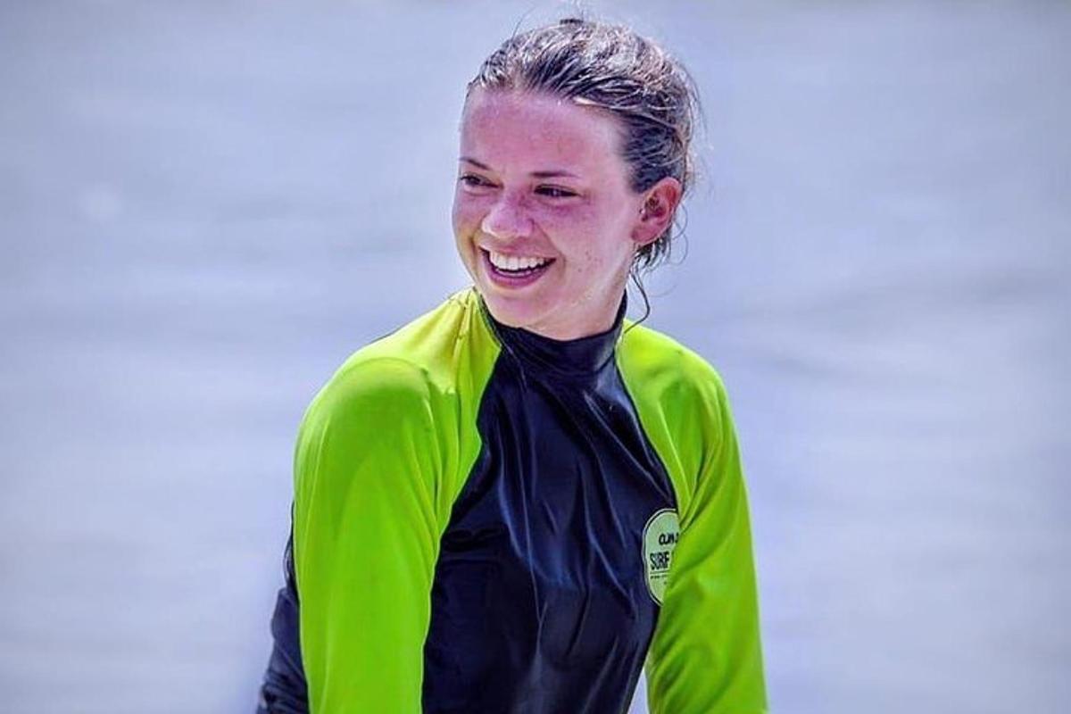 a woman in a green jacket is smiling