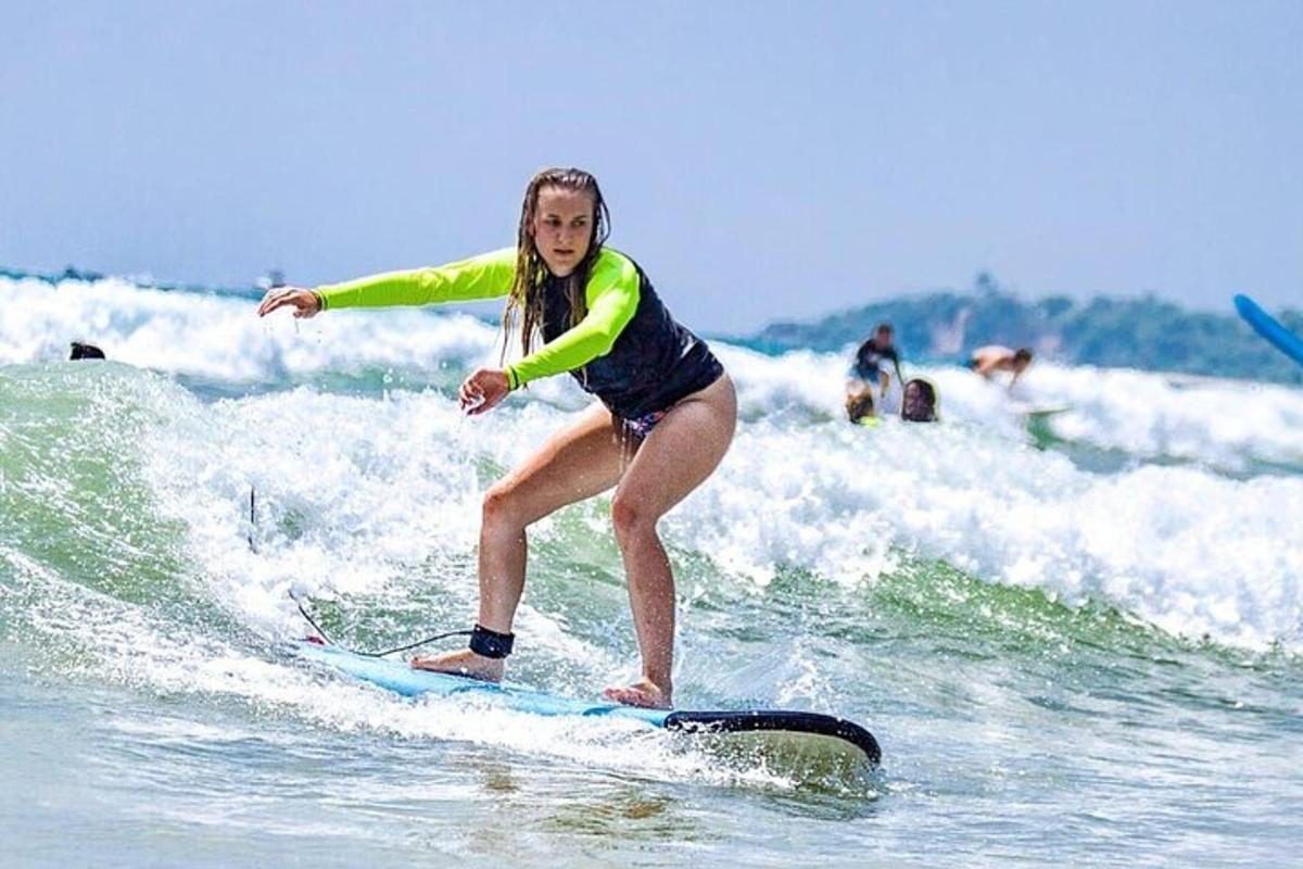 a woman riding a wave on a surfboard in the ocean