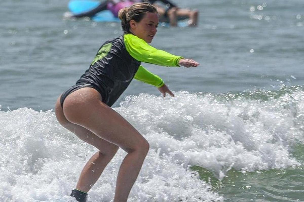a woman riding a wave on a surfboard in the ocean