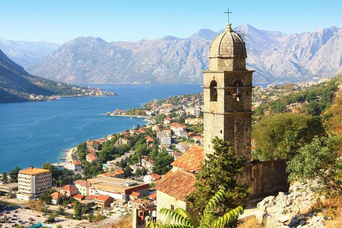 a view of a town with a tower and water