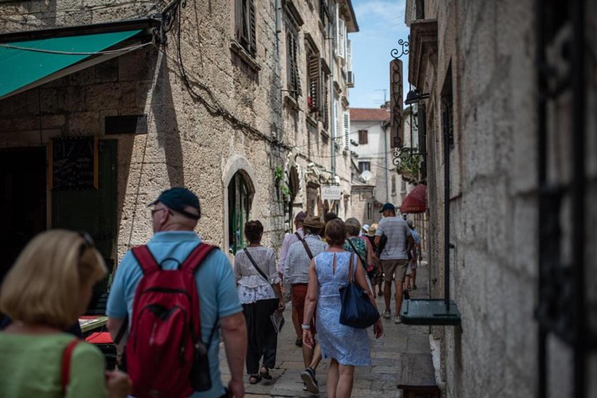 a group of people walking down an alley