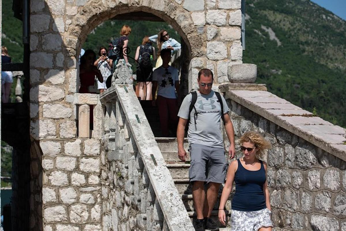a man and woman walking on a stone bridge