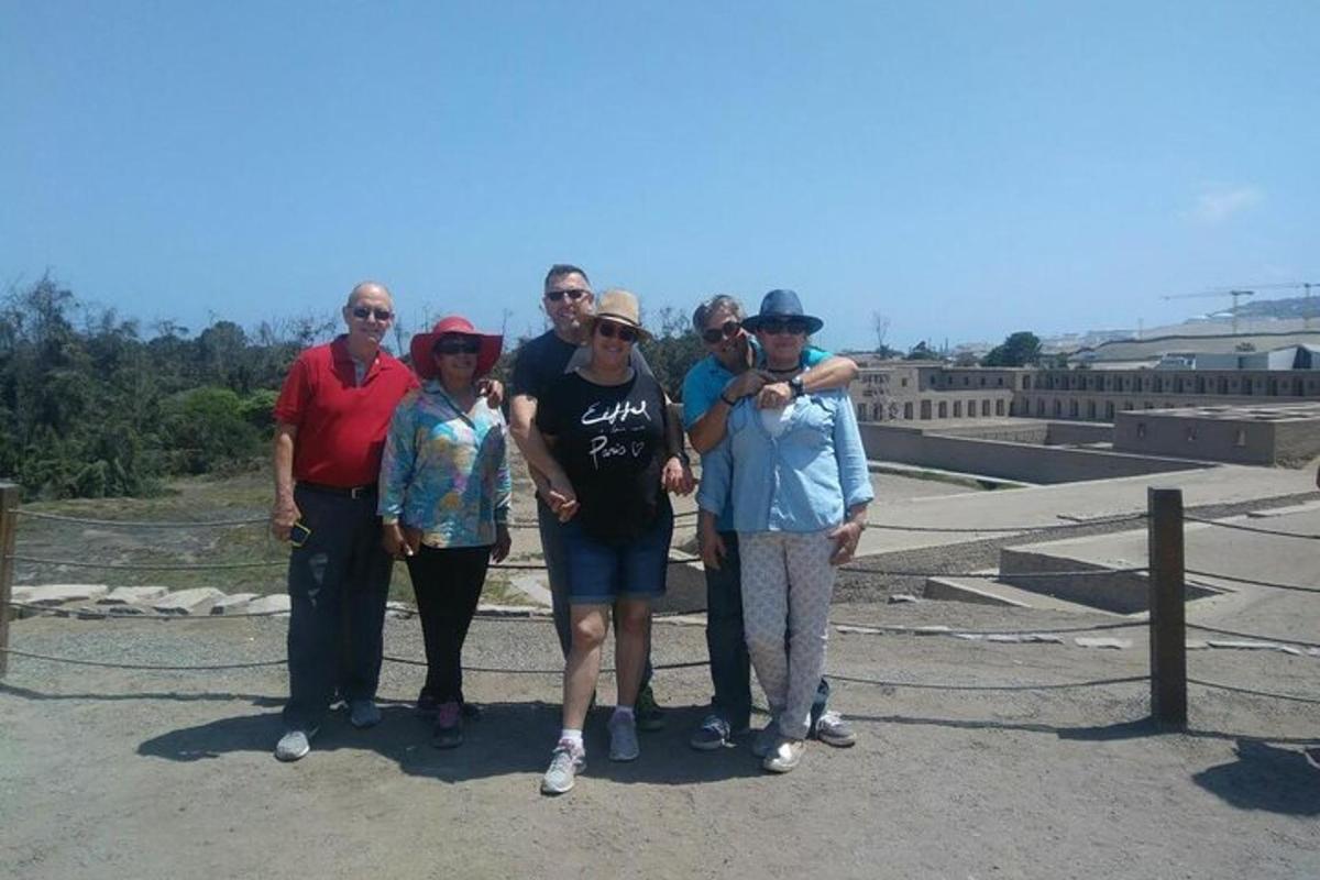 a group of people posing for a picture at the top of a bridge