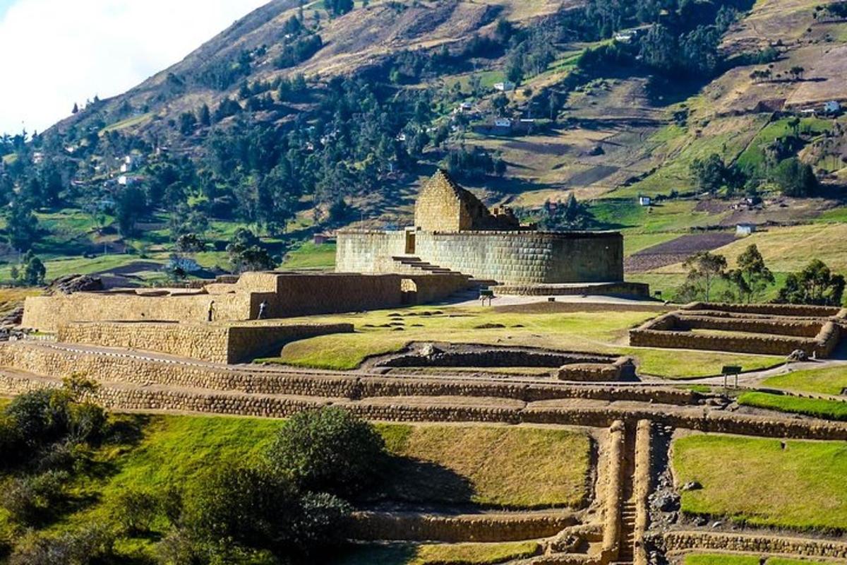 a building on a hill with a mountain in the background
