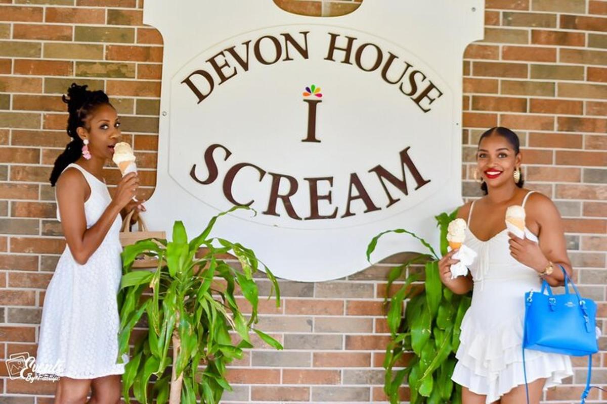 two girls eating ice cream in front of a sign
