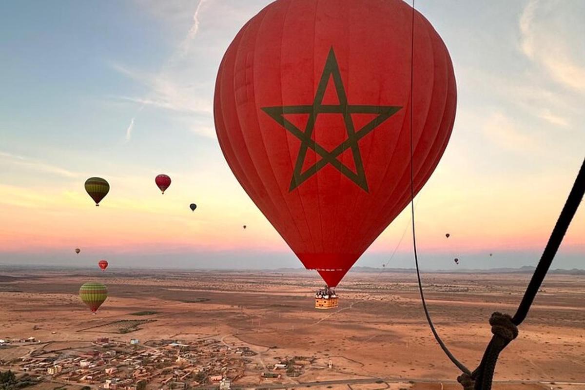 a group of hot air balloons flying over a city