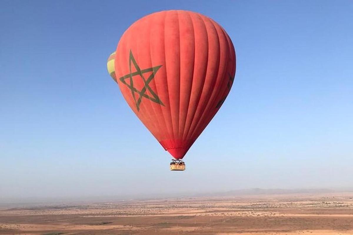 a red hot air balloon flying in the sky