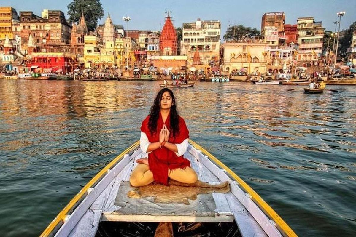 a woman sitting in a boat in the water