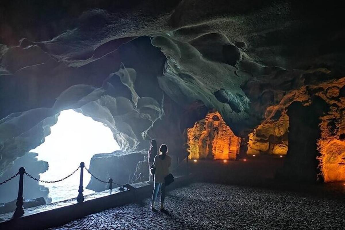 a person standing in front of a cave