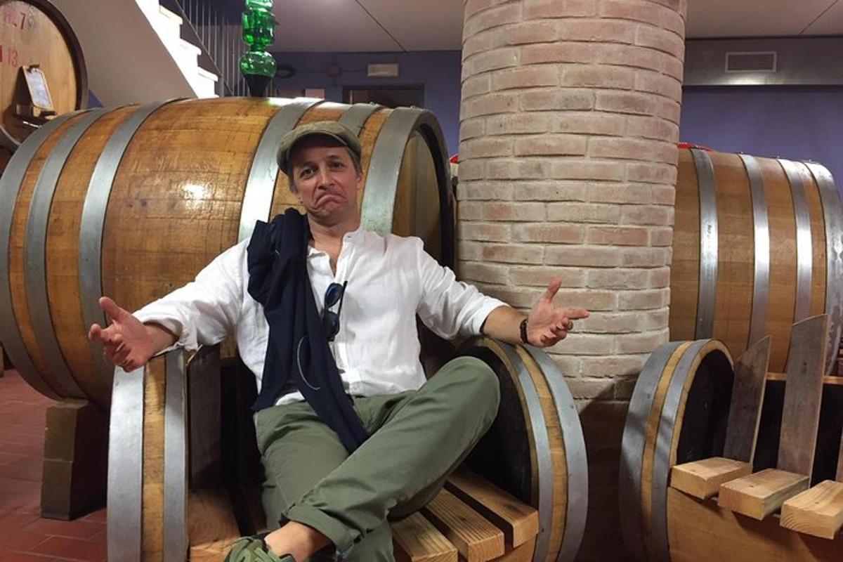 a man is sitting in a barrel