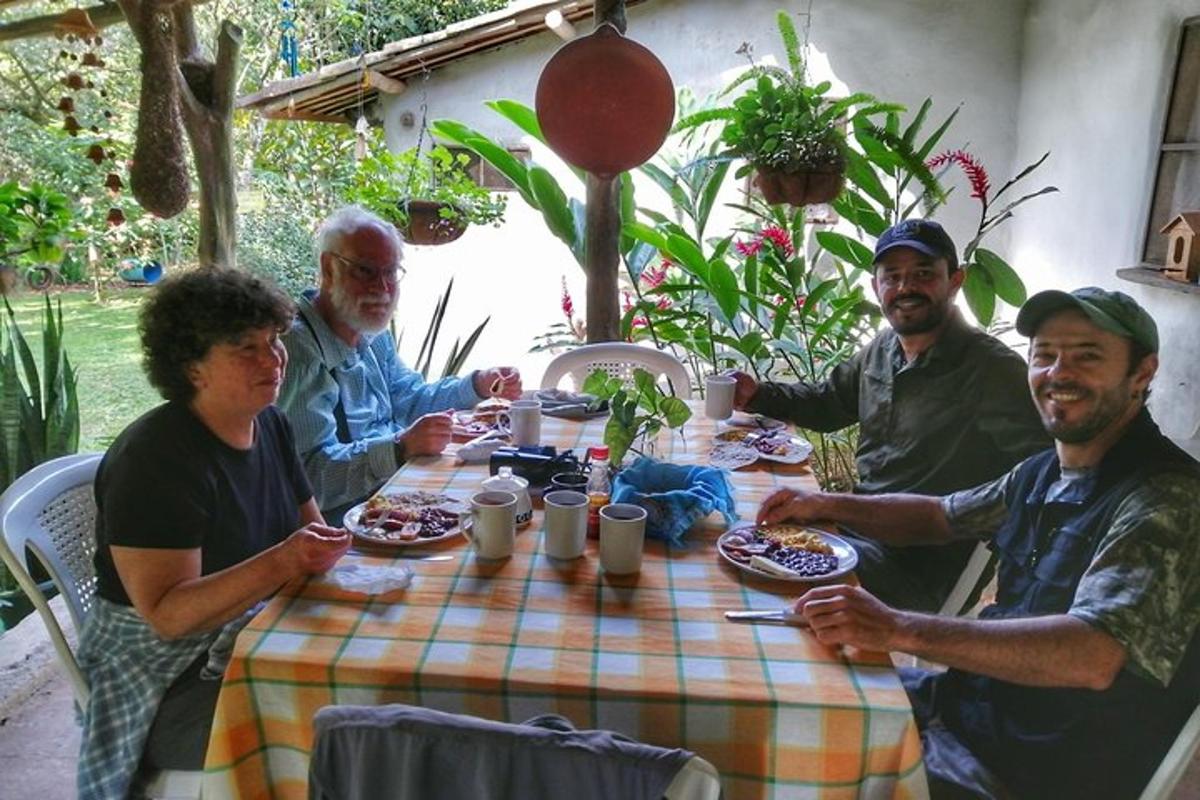 a group of men sitting around a table eating food