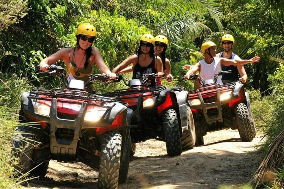 isang grupo ng mga tao na nakasakay sa mga atv sa isang trail