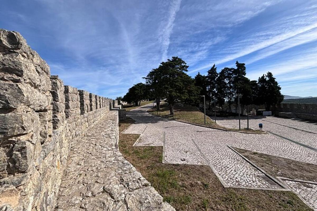 a stone retaining wall next to a street
