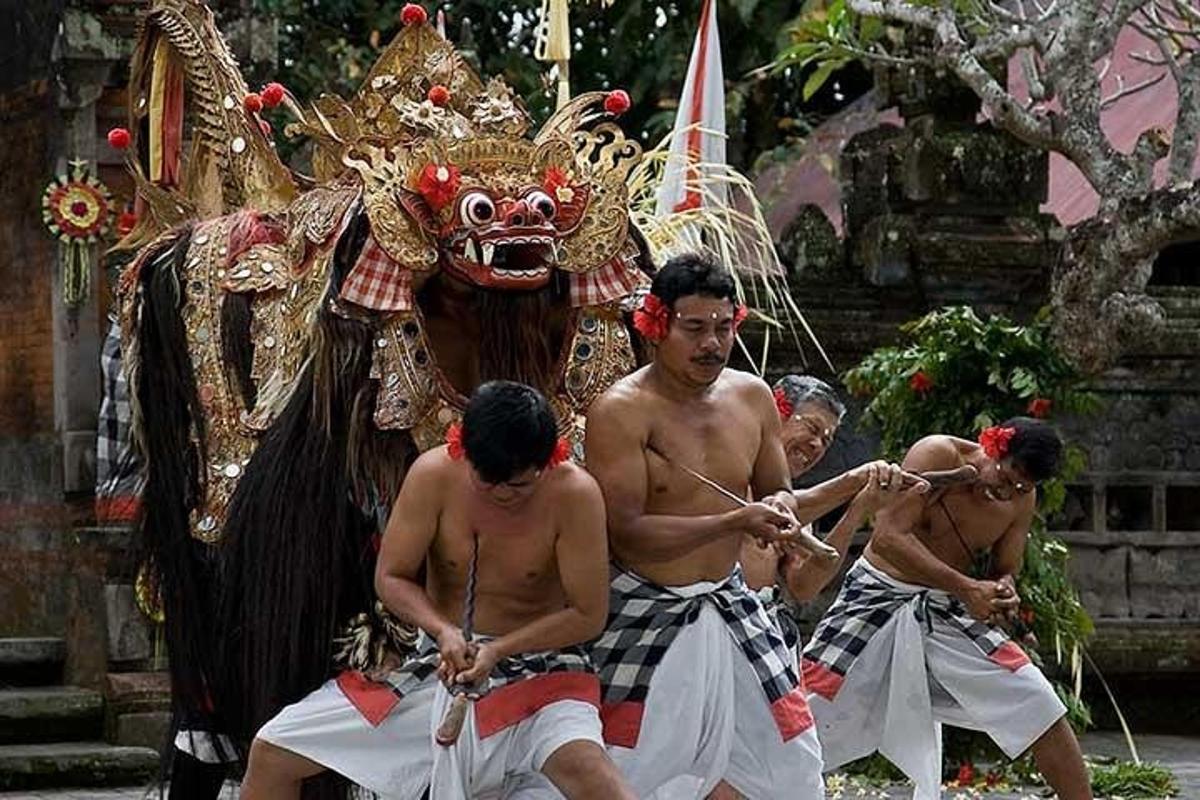 a group of men in front of a person wearing a mask