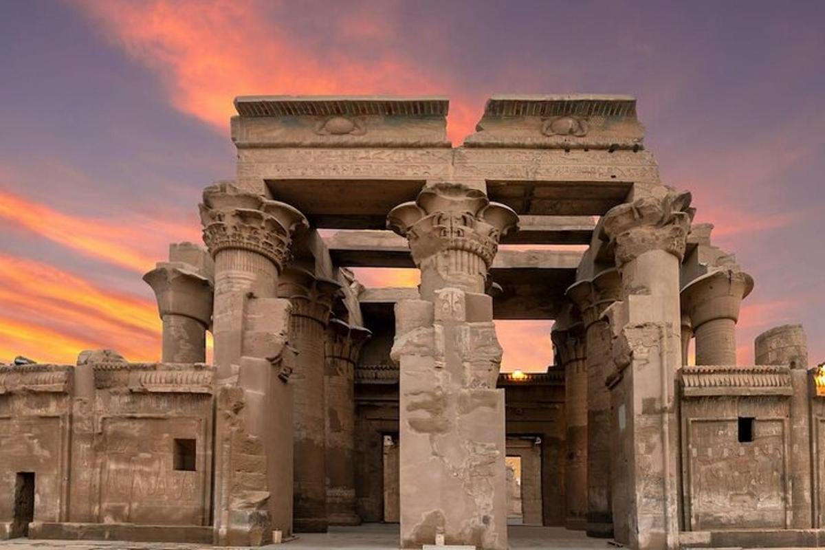 an ancient building with a sunset in the background