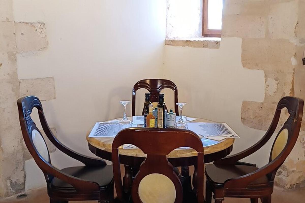 a wooden table with two chairs and a table with drinks on it