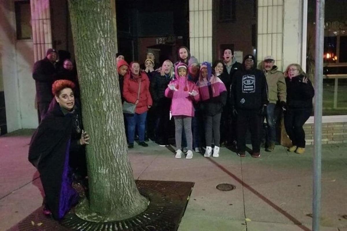a group of people standing around a tree