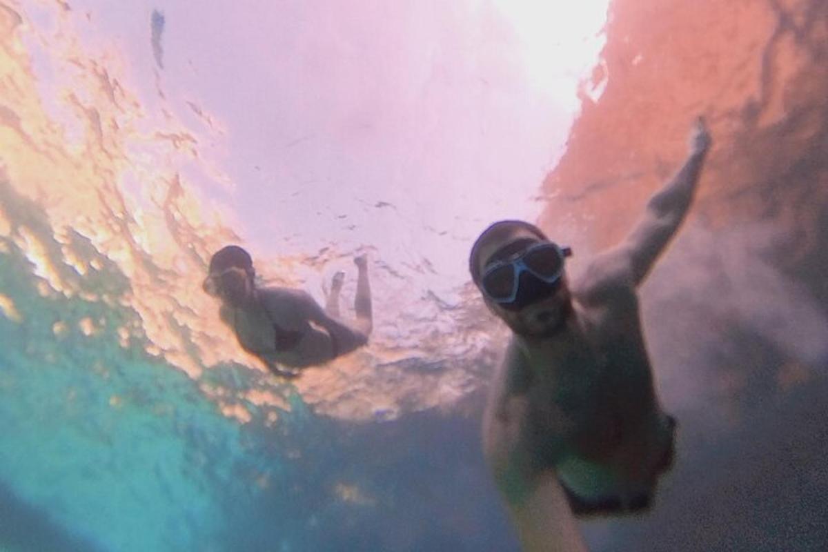 two men in the water with their arms in the water