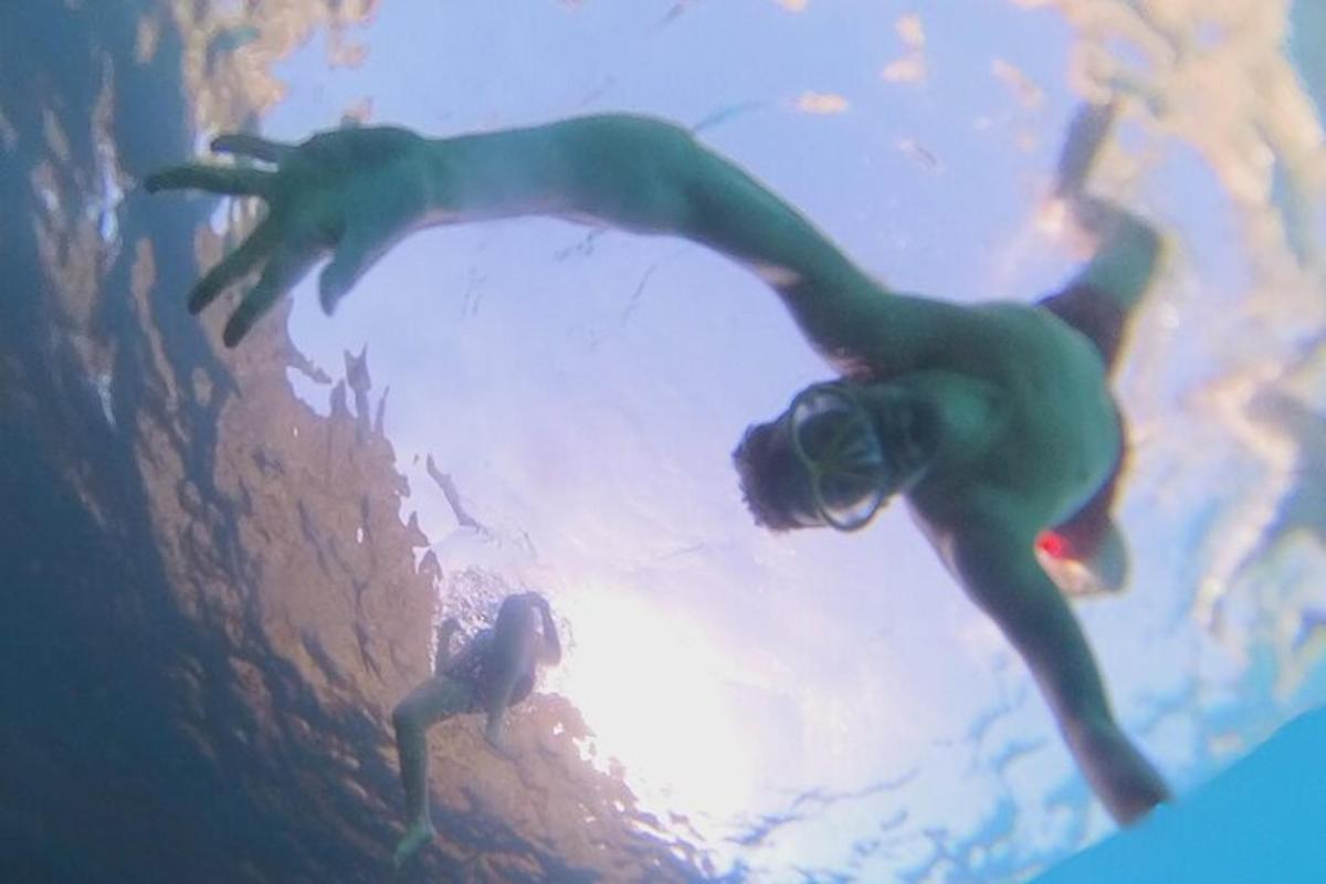 a man in a wetsuit swimming in the water