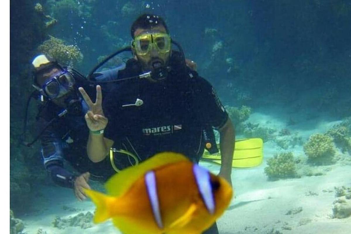 a couple of people in the water with a fish