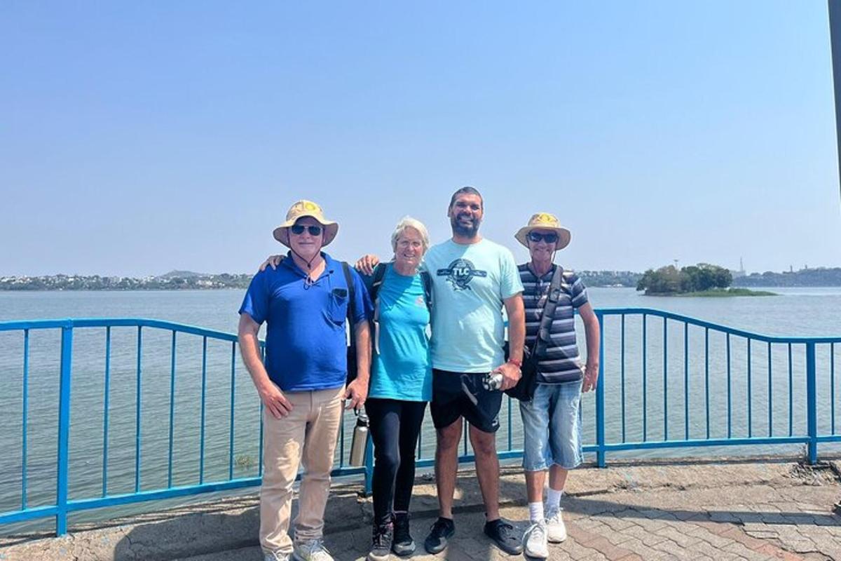 a group of people standing next to the water