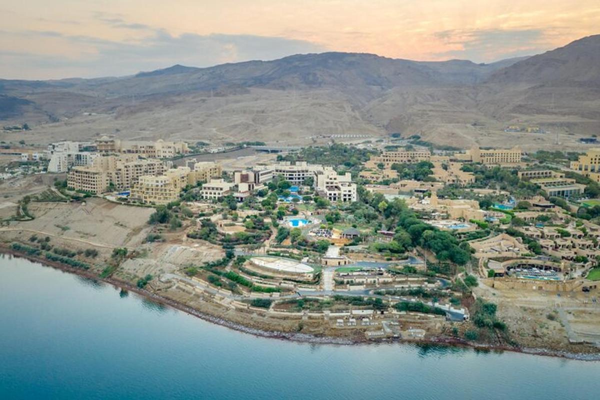 an aerial view of a city next to a body of water
