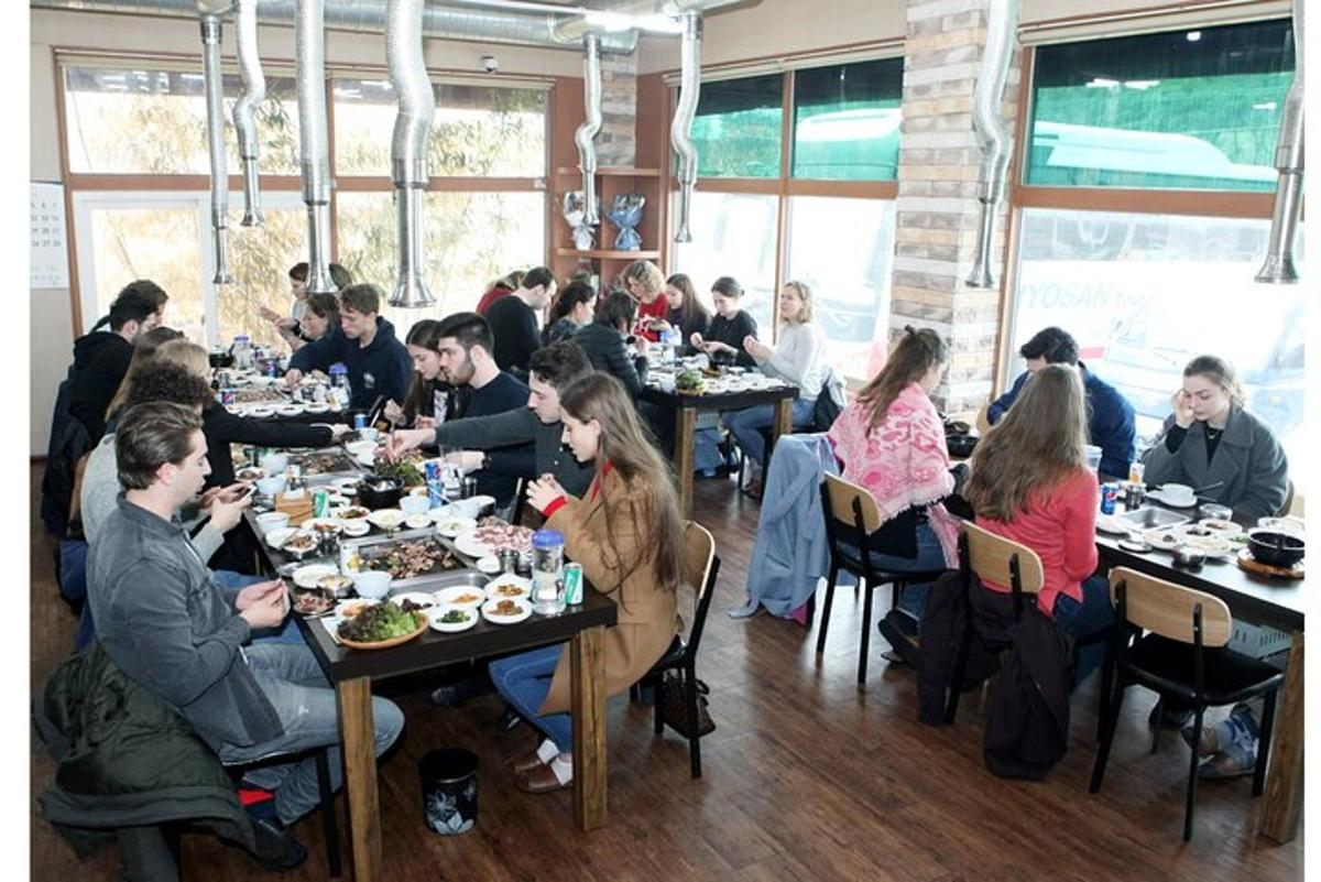 skupina lidí sedících u stolů v restauraci