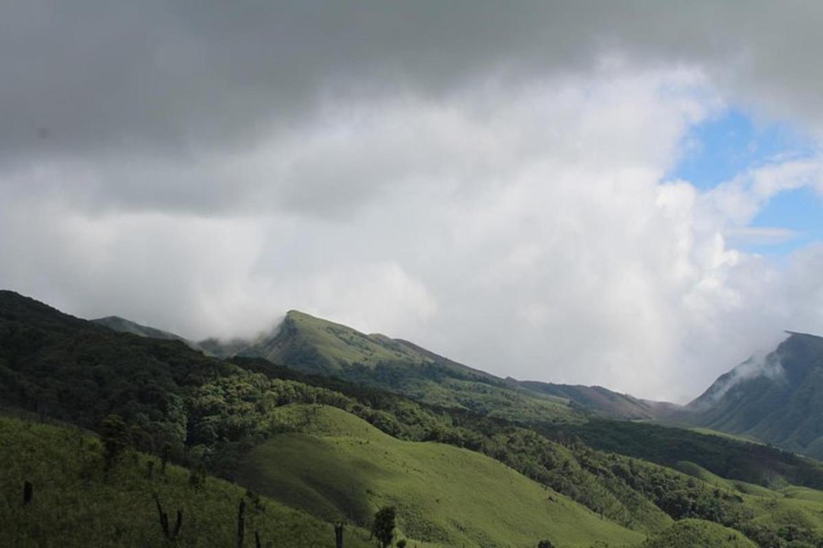 a misty valley with green hills and mountains