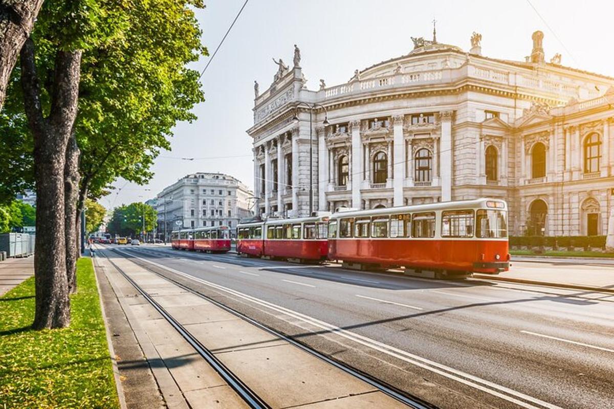 a row of red trolley cars in front of a building