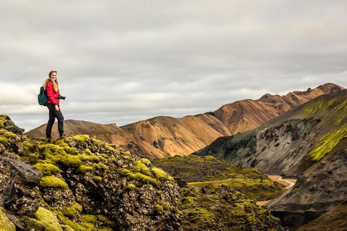 a woman standing on top of a mountain