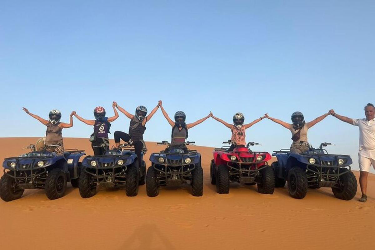 isang grupo ng mga tao sa atvs sa disyerto