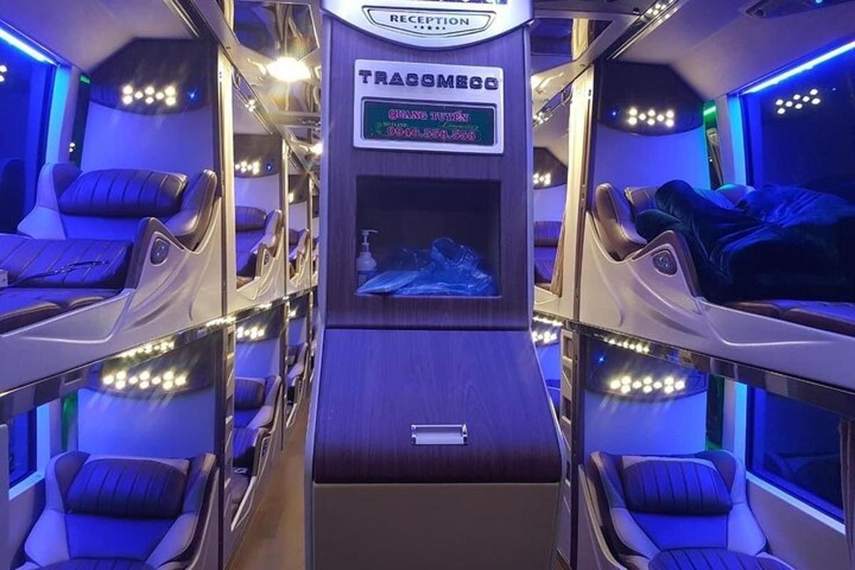 an empty train car with purple seats and a sign