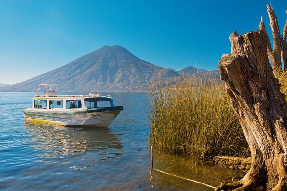 a boat in the water with a mountain in the background