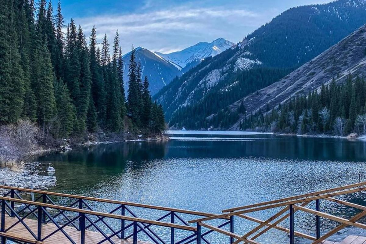 a view of a lake with a wooden bridge